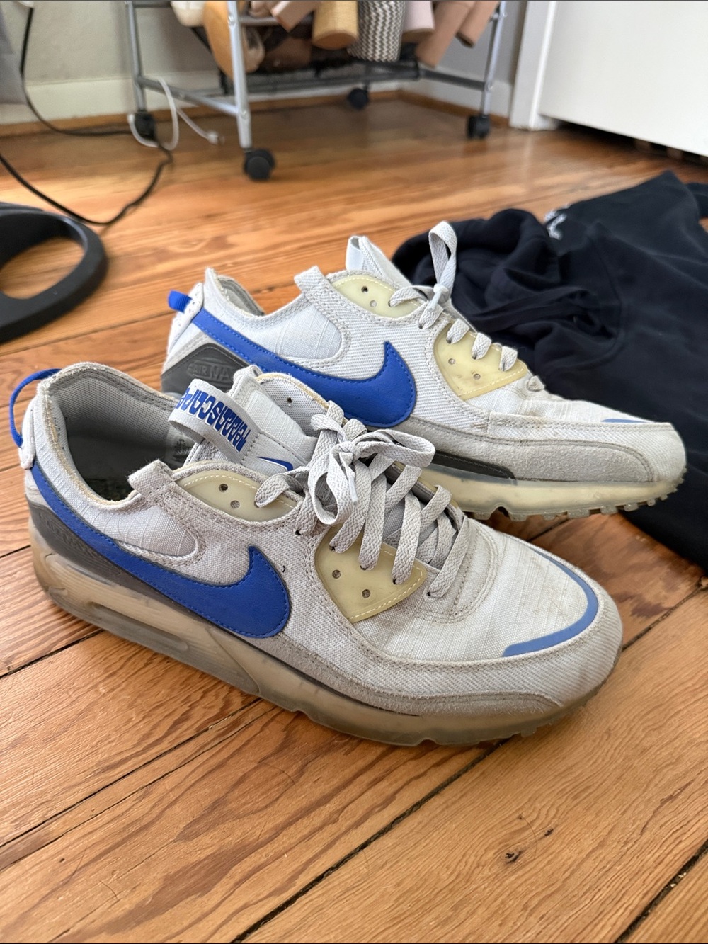 Nike beige cream sneakers with blue swoosh
